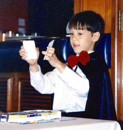 Leland performing magic as a child